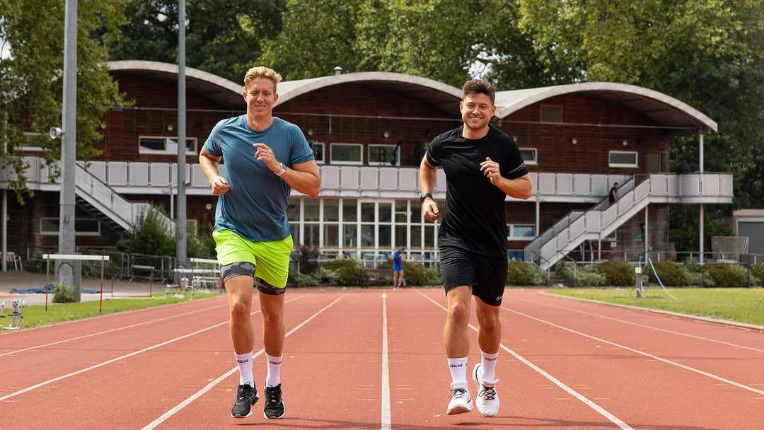 guys running on a track in grip socks